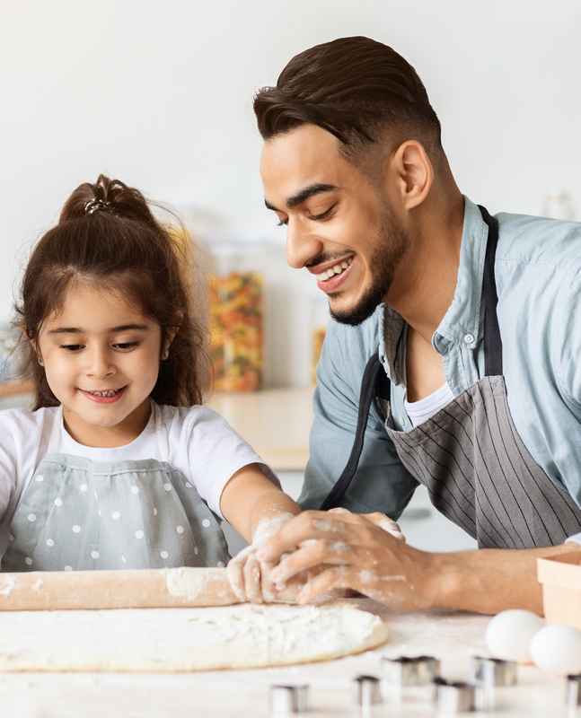dad and kid cooking for mom